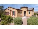 Tan two-story house with a two-car garage at 42086 W Solitare Dr, Maricopa, AZ 85138