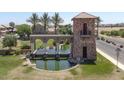 Gated community entrance with a water feature and landscaping at 36503 W San Ildefanso Ave, Maricopa, AZ 85138