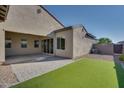 Backyard with covered patio and artificial turf at 17279 W Dartmouth St, Surprise, AZ 85388