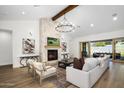 Spacious living room with a stone fireplace and large windows at 2144 E San Juan Ave, Phoenix, AZ 85016