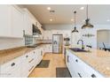 Spacious kitchen with an island, stainless steel appliances, and white shaker cabinets at 18226 W Desert Willow Dr, Goodyear, AZ 85338