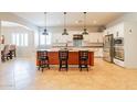 Spacious kitchen with an island, stainless steel appliances, and white shaker cabinets at 18226 W Desert Willow Dr, Goodyear, AZ 85338