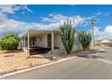 Mobile home with covered porch and desert landscaping at 11596 W Sierra Dawn Blvd # 157, Surprise, AZ 85378