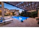 Inviting pool and spa area with lounge chairs and pergola at 9848 E Parkside Ln, Scottsdale, AZ 85255