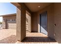 Covered entryway with a gray door and stone accents at 8628 W Solano Dr, Glendale, AZ 85305