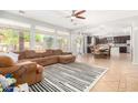 Open living room and kitchen with a large sectional sofa at 3702 W Riordan Ranch Rd, Phoenix, AZ 85083