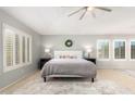 Bright bedroom with a large bed and plantation shutters at 3702 W Riordan Ranch Rd, Phoenix, AZ 85083