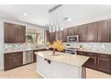 Modern kitchen with granite countertops and dark cabinets at 3702 W Riordan Ranch Rd, Phoenix, AZ 85083