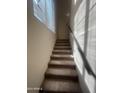 Indoor stairs with carpeted steps and railing at 2450 W Glenrosa Ave # 12, Phoenix, AZ 85015
