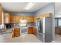 Kitchen with stainless steel appliances and wood cabinets at 816 W Hess Ave, Coolidge, AZ 85128