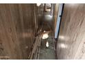 Hallway with exposed pipes and damaged flooring at 65 S Mountain Rd, Apache Junction, AZ 85120