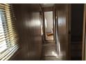 A long narrow hallway with wood paneling and minimal features at 65 S Mountain Rd, Apache Junction, AZ 85120