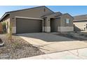 House exterior with driveway and drought-tolerant landscaping at 37457 W San Clemente St, Maricopa, AZ 85138