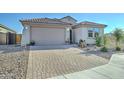 House exterior showcasing a two-car garage and well-maintained landscaping at 1957 W Fawn Way, San Tan Valley, AZ 85144