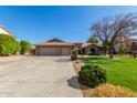 Two-story house with three-car garage and landscaped lawn at 10913 N 153Rd Ln, Surprise, AZ 85379