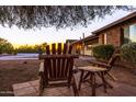 Rustic patio furniture overlooking a tranquil sunset view at 11082 W Martin Rd, Casa Grande, AZ 85194