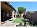 Relaxing patio with a fountain, artificial turf, and seating area at 3771 E Hazeltine Way, Chandler, AZ 85249