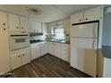 Cozy kitchen with white cabinets and wood floors at 7807 E Main St # D26, Mesa, AZ 85207