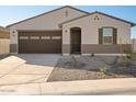 Single story home with brown garage door and neutral color scheme at 37517 W San Clemente St, Maricopa, AZ 85138