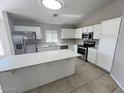 Modern kitchen with island and stainless steel appliances at 12753 W Myer Ln, El Mirage, AZ 85335