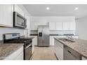 Modern kitchen with stainless steel appliances and granite countertops at 40095 W Venture Rd, Maricopa, AZ 85138