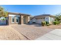 Single-story home with landscaped yard and two-car garage at 5309 N 148Th Ave, Litchfield Park, AZ 85340