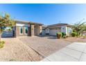 Single-story home with landscaped yard and two-car garage at 5309 N 148Th Ave, Litchfield Park, AZ 85340