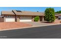 Brick ranch house with two-car garage and solar panels at 6034 E Hillview St, Mesa, AZ 85205