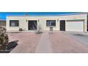 Single story home with a garage and gated walkway at 3002 W Latham St, Phoenix, AZ 85009