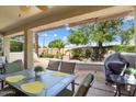 Covered patio with seating area and built-in grill at 22303 N Montecito Ave, Sun City West, AZ 85375