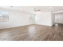 Spacious living room with wood-look tile floors and lots of natural light at 15112 W Hadley St, Goodyear, AZ 85338