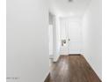 Bright entryway with wood-look tile flooring and access to other rooms at 15112 W Hadley St, Goodyear, AZ 85338