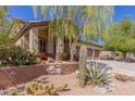 Front yard landscaping with cacti and trees at 10956 S Oakwood Dr, Goodyear, AZ 85338