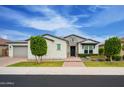 Two story home with gray garage door and brick accents at 4072 E Zion Way, Chandler, AZ 85249