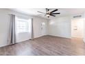 Living room with hardwood floors and ceiling fan at 676 N 6Th Pl, Coolidge, AZ 85128