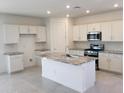 Modern kitchen with granite island and white cabinets at 20542 N 226Th Ln, Surprise, AZ 85387