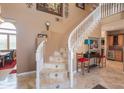 Elegant curved staircase with beige tile and white railings at 753 E Mountain Sky Ave, Phoenix, AZ 85048