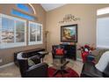 Cozy living room featuring dark leather furniture and a large piece of artwork at 753 E Mountain Sky Ave, Phoenix, AZ 85048