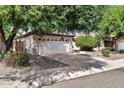 Single-story home with a two-car garage and mature trees at 8174 W Marco Polo Rd, Peoria, AZ 85382