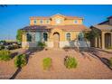 Two-story house with tan exterior, brown roof, and landscaping at 5476 W Fulton St, Phoenix, AZ 85043