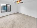 Bright bedroom with carpeted floors and large window at 2199 E Gillcrest Rd, Gilbert, AZ 85298