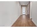 Long hallway with wood-look tile floors and barn door at 17715 E Cindercone Rd, Rio Verde, AZ 85263