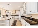 Spacious kitchen boasts granite countertops, white cabinetry, and a large island at 2301 E Azalea Dr, Chandler, AZ 85286