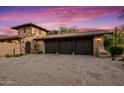 Three-car garage with dark brown doors at 36975 N Mirabel Club Dr, Scottsdale, AZ 85262
