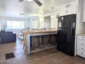 Open kitchen boasts a rustic island and flows into the living area at 7300 N 51St Ave # F93, Glendale, AZ 85301