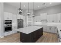 Modern kitchen with large island and white cabinets at 15436 E Dixileta Dr, Scottsdale, AZ 85262