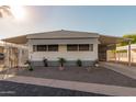 Single-wide manufactured home with carport and landscaped yard at 7300 N 51St Ave # G130, Glendale, AZ 85301