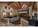 Spacious living room with high ceilings, chandeliers, and fireplace at 8530 E Via Montoya --, Scottsdale, AZ 85255