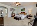 Bright bedroom with a comfortable bed and a sitting area at 3660 S Golden Eye Ln, Gold Canyon, AZ 85118