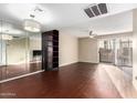 Spacious living room with hardwood floors and a large mirror at 1601 W Sunnyside Dr # 154, Phoenix, AZ 85029